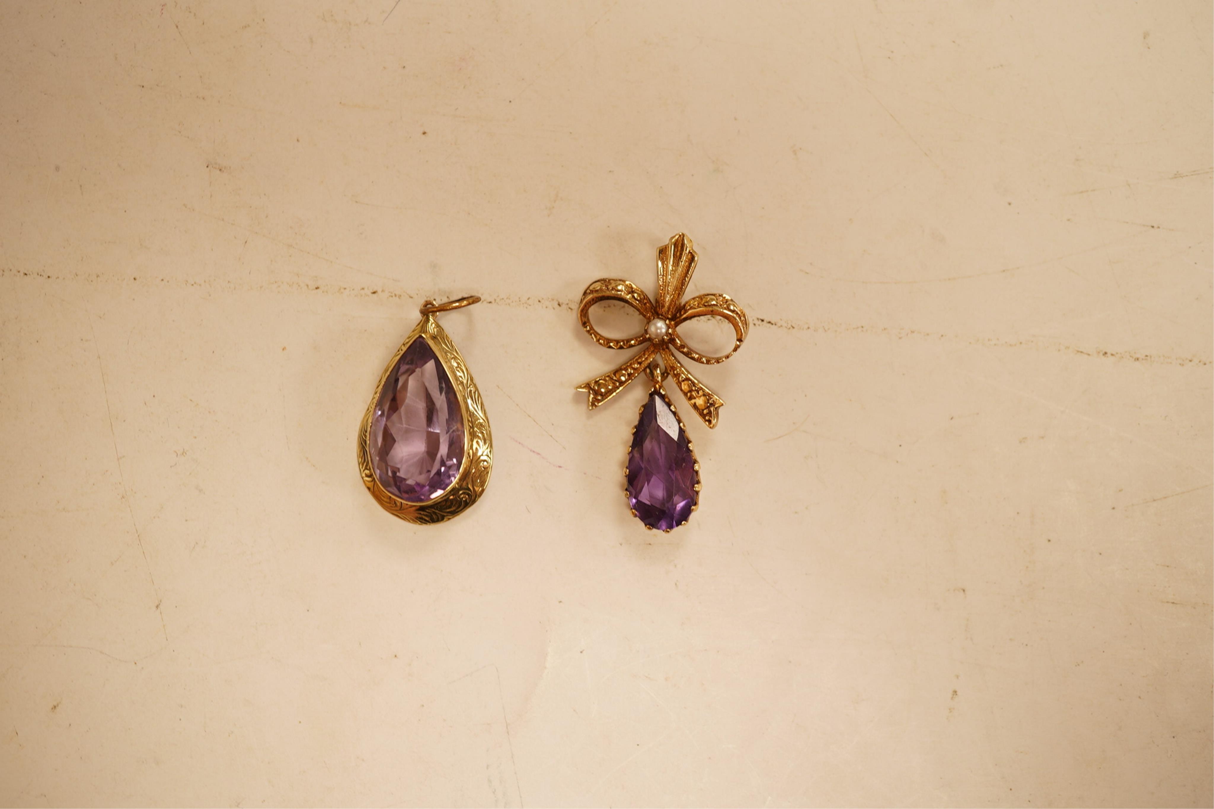 A 1970's 9ct gold, amethyst and seed pearl set drop pendant, 29mm, together with a yellow meta and amethyst set drop pendant.